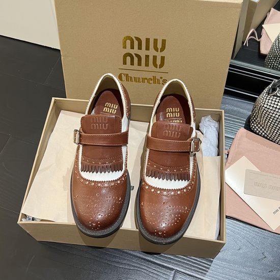 Miu Miu Elegant Tassel Loafers with Baroque Carving
